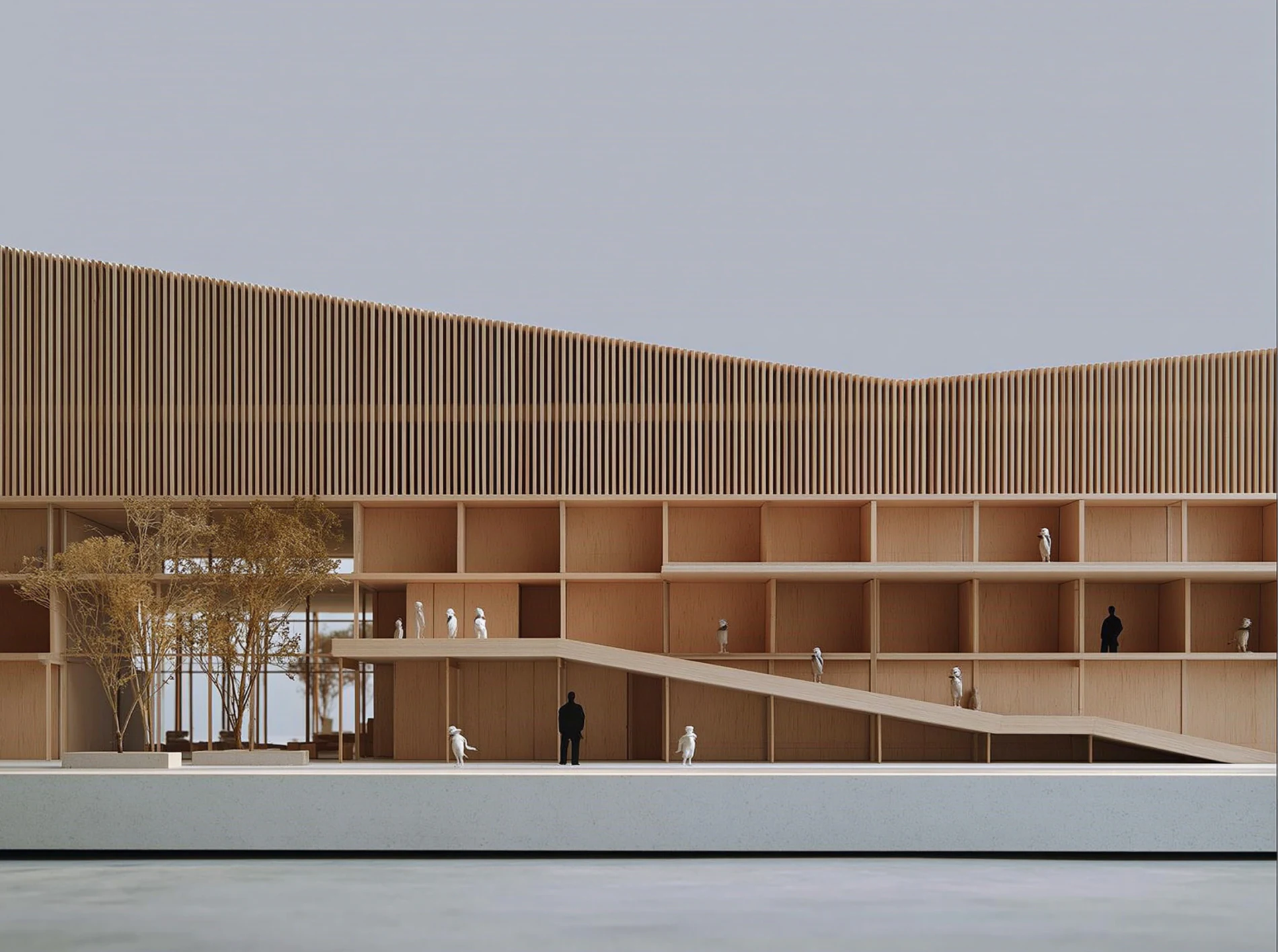 A pale ribbed civic building with a long ramp running the length of its facade.